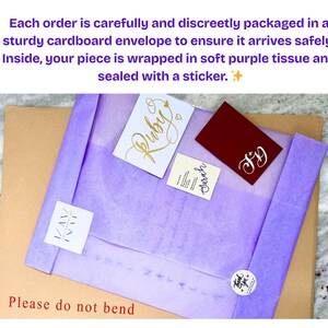 May include: A brown cardboard envelope with the text Please do not bend, containing a purple tissue-wrapped package sealed with a sticker. Included are three small cards with the text Ruby, Sarah, and FD, and a square label with the text KAM NAT.