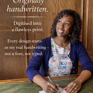May include: A navy blue cardigan worn over a white top with a colorful postage stamp pattern. The text reads: Originally handwritten. Digitised into a flawless print. Every design starts as my real handwriting&mdash;not a font, not typed.