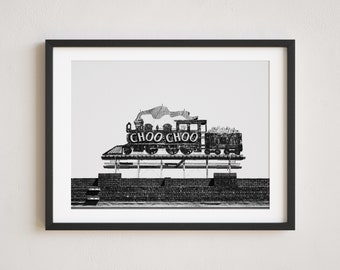 May include: Black and white photograph of a vintage train sign with the words "Choo Choo" on it. The sign is mounted on a brick wall.