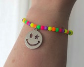 Neon glass bead smiley face charm stretch bracelet