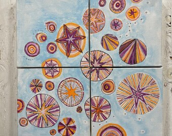May include: A set of four square canvases with a blue background and a pattern of orange, yellow, and purple circles and stars. The circles have a striped pattern and the stars are in the center of the circles.