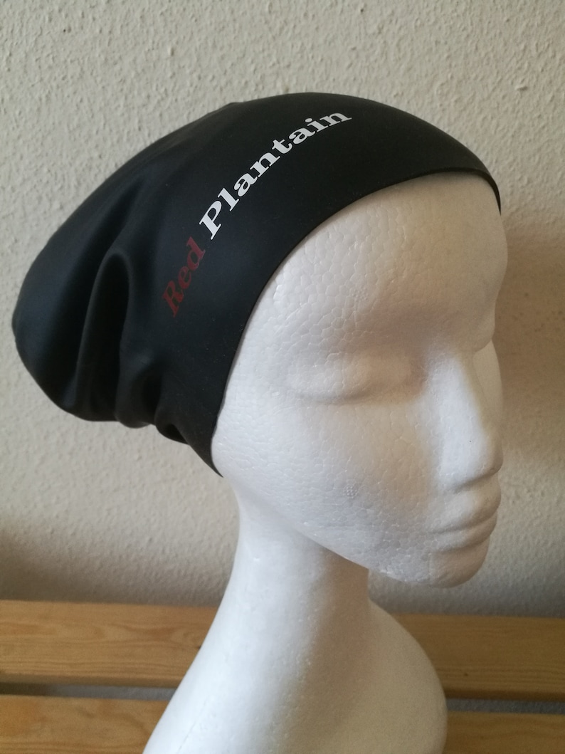 May include: Black swim cap with the text "Red Plantain" in white lettering.