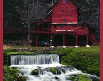 May include: A red wooden water mill with a water wheel and a sign that reads "Hodgson Water Mill" is situated next to a small waterfall.