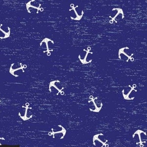 May include: A blue fabric with a white anchor pattern. The anchors are scattered randomly across the fabric. The fabric has a distressed look, as if it has been worn and faded.