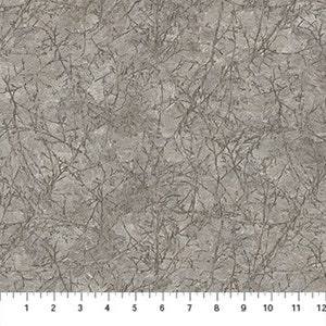 May include: A close-up of a gray fabric with a textured surface. The fabric features a pattern of thin, dark gray lines resembling branches or veins. A ruler is placed along the bottom edge, showing measurements in inches.