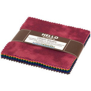 May include: A pack of 10 charm squares in a variety of colors, including red, orange, yellow, green, blue, indigo, and violet. The fabric is a soft, textured cotton blend. The squares are 5 inches by 5 inches. The label reads "Hello My Name Is Charm Square".