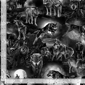 May include: A black and white fabric print featuring multiple wolves in various poses, including running, standing, and howling against a moonlit landscape. A vertical ruler on the left side shows measurements in inches from 0 to 11 inches.