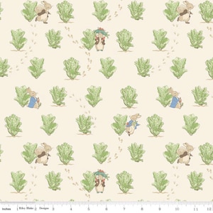 May include: A repeating pattern featuring illustrations of rabbits, green lettuce, and footprints on a cream-colored background. The rabbits are depicted in various poses, some wearing blue jackets and hats. The design is reminiscent of a children's storybook.