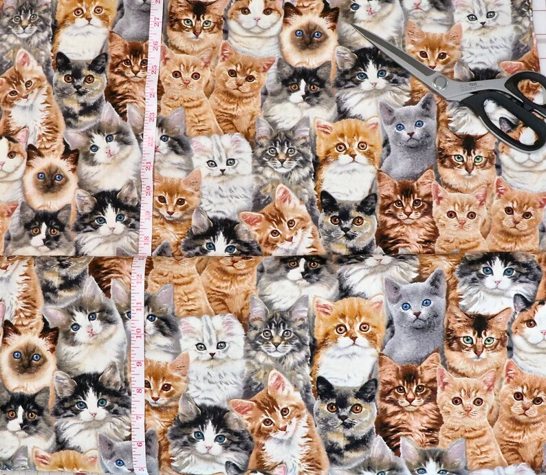 May include: A colorful fabric featuring a repeating pattern of cats in various poses and colors. The fabric is a blend of blues, greens, browns, and oranges.