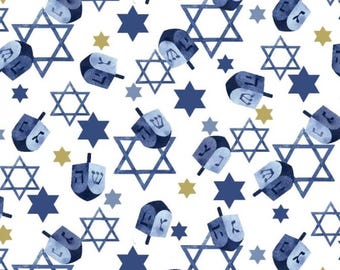 May include: A white background is covered with a pattern of blue dreidels, Star of David symbols, and six-pointed stars in shades of blue and gold. The dreidels have Hebrew letters on them.