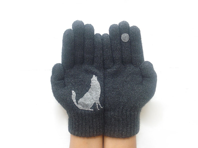 Charcoal winter gloves with a gray wolf in one palm and howling at the full moon on the other hand's middle finger. Fun, unique and cozy gloves and perfect gift for winter.
