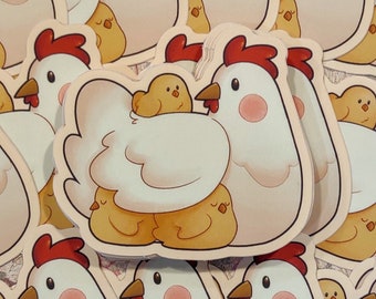 May include: A set of white chicken stickers with yellow chicks. The chickens are depicted with closed eyes and have pink cheeks. The chicks are nestled under the wings of the mother chickens.