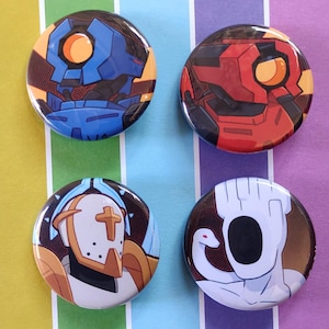 May include: Four circular pin badges with robot-themed illustrations. The badges feature designs in blue, red, white, and brown, with orange accents. The badges are arranged on a striped background of yellow, green, purple, and white.