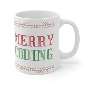 May include: White ceramic mug with a red and green knitted pattern and the text "MERRY CODING" in red and green.