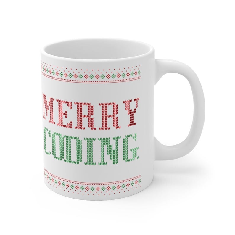 May include: White ceramic mug with a red and green knitted pattern and the text "MERRY CODING" in red and green.