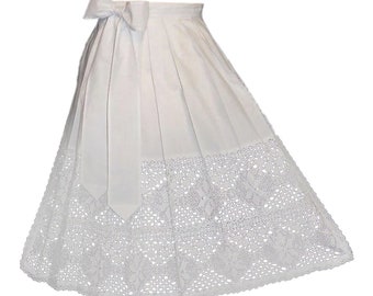 May include: A white skirt with a pleated design and a decorative lace hem. The skirt features a large bow at the waist and is made of a lightweight fabric. The skirt is suitable for special occasions.