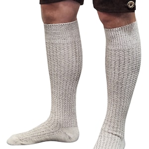 May include: A pair of white knee-high socks with a textured knit pattern.