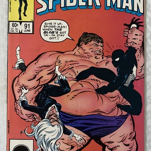 May include: A comic book cover featuring Spider-Man in a black suit fighting a large, red, and purple character called "The Blob". The cover is red with the title "Peter Parker, The Spectacular Spider-Man" in white letters. The comic book is issue number 91 and is dated June.