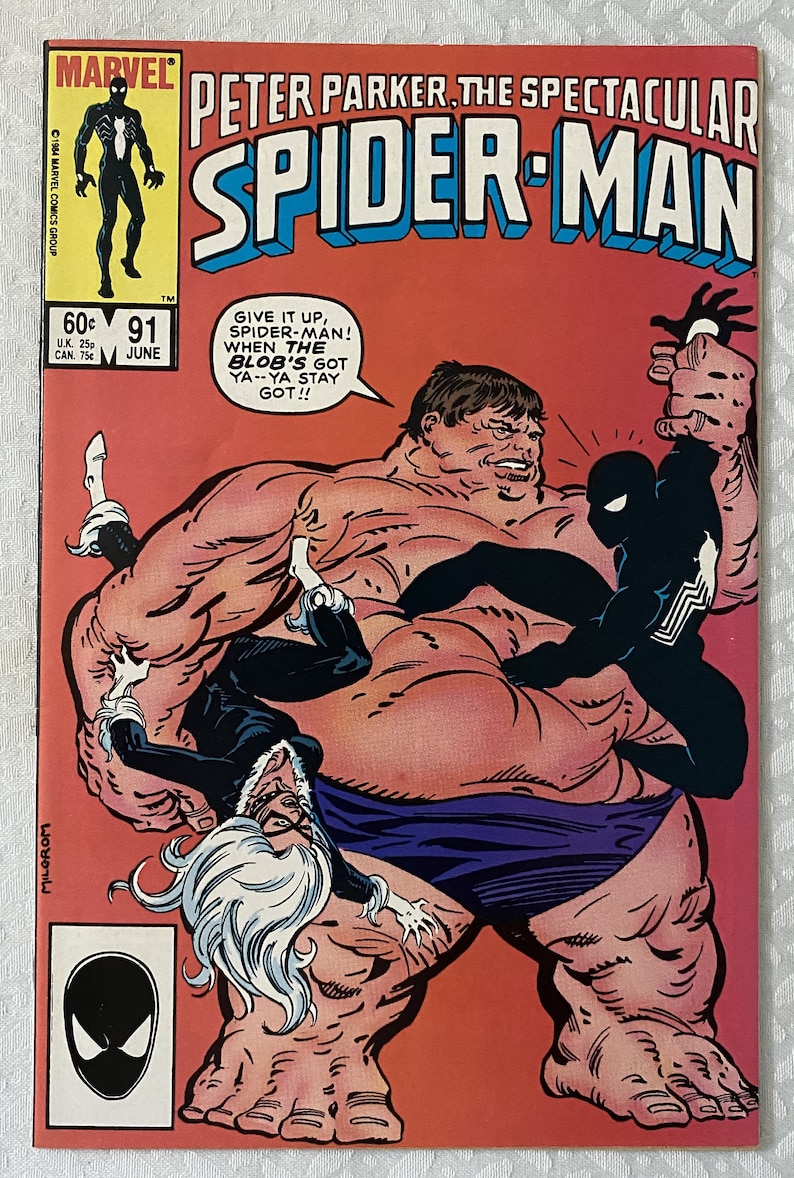 May include: A comic book cover featuring Spider-Man in a black suit fighting a large, red, and purple character called "The Blob". The cover is red with the title "Peter Parker, The Spectacular Spider-Man" in white letters. The comic book is issue number 91 and is dated June.