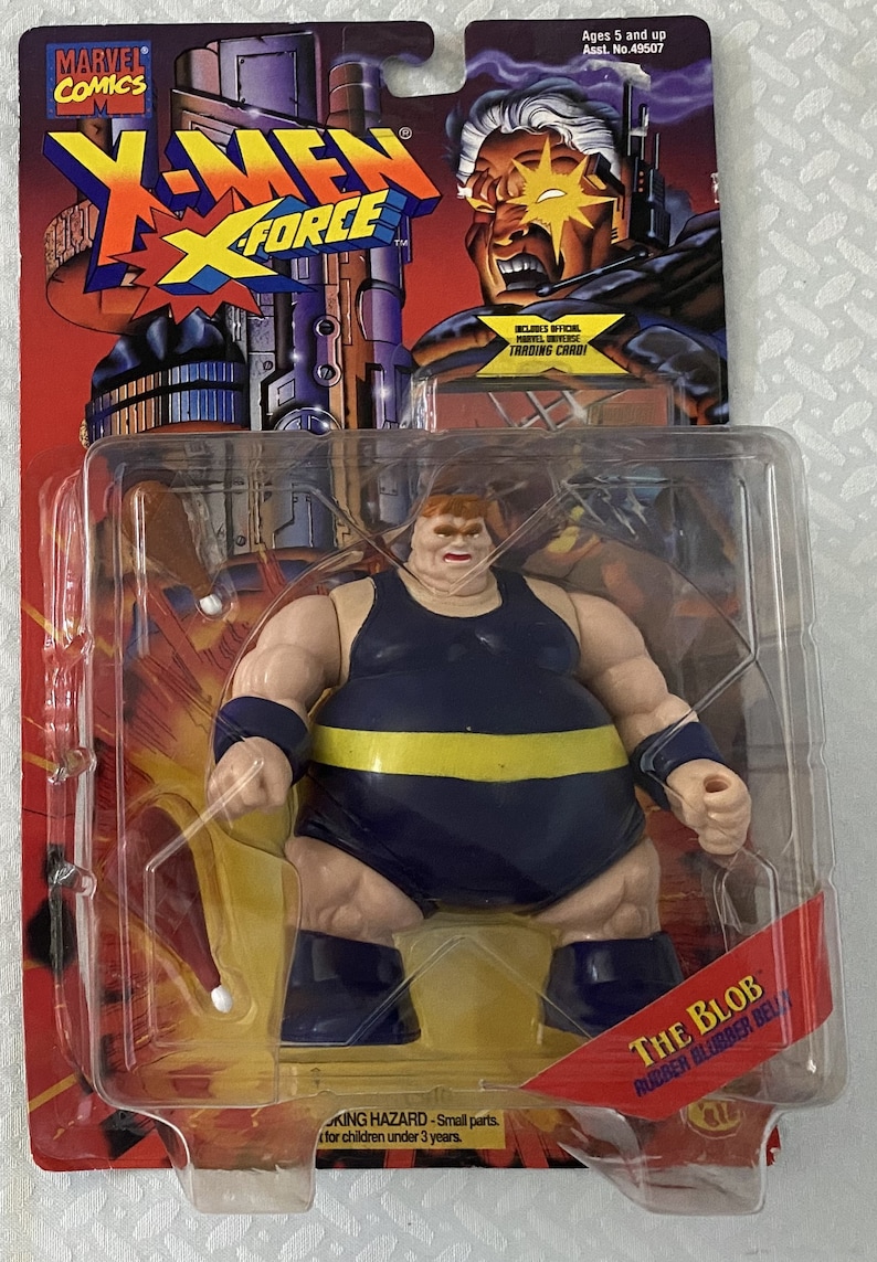 May include: A plastic action figure of The Blob from the X-Men comics. The figure is wearing a blue and yellow costume and has a large, rubbery belly. The figure is packaged in a plastic blister pack with a red and yellow background. The packaging includes the text "The Blob" and "Rubber Blubber Belly".