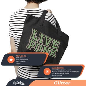 May include: Black tote bag featuring the text "LIVE PUNK" in green and white. The bag is carried over a person's shoulder. The bag is made of cotton, polyester, and leather.