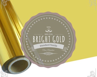 May include: A roll of bright gold foil with a label that reads "NOVA NRD FOIL BRIGHT GOLD Standard Textile Nova Rhinestone".