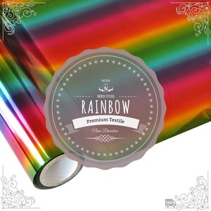 May include: A roll of rainbow holographic heat transfer vinyl for crafting projects. The vinyl is iridescent and has a metallic sheen. The label reads "Nova NRD Foil Rainbow Premium Textile Non-Rhinestone".