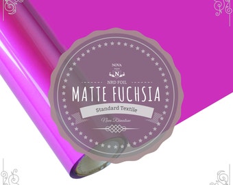 May include: A roll of matte fuchsia heat transfer vinyl for crafting projects. The vinyl is labeled "Nova NRD Foil Matte Fuchsia Standard Textile New Rhinestone".