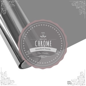 May include: A roll of chrome-colored heat transfer vinyl with a label that reads "Nova NRD Foil Chrome Standard Textile Nova Rhinestone".