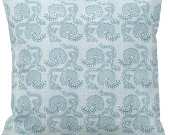 May include: A light blue throw pillow with a repeating pattern of stylized blue flowers and leaves.