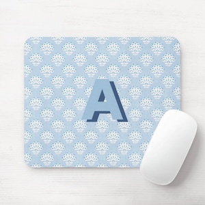 May include: A blue and white patterned mouse pad with the letter "A" in a blue 3D font.