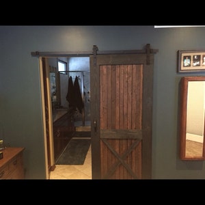 Sliding barn door with hardware