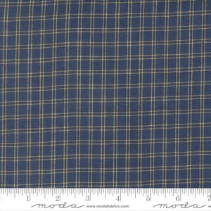 May include: Close-up of a fabric with a navy blue background and a grid pattern of thin, tan lines. The fabric has a woven texture and is suitable for quilting or other craft projects. The image includes a ruler along the bottom.