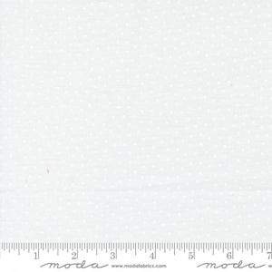 May include: White fabric with a repeating pattern of small, white stars. The fabric has a subtle texture and is measured with an inch ruler along the bottom edge. The brand name "moda" is printed on the ruler.