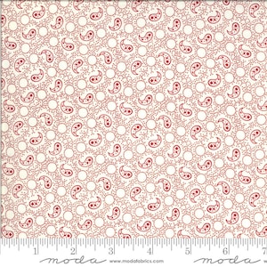 May include: White fabric with a red paisley pattern and white polka dots. The fabric is measured with a ruler that reads "moda" at the 5 cm and 15 cm marks.