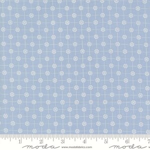 May include: Light blue fabric with a repeating white floral pattern. The design features small white flowers arranged in a grid pattern, creating a delicate and symmetrical look. The fabric is suitable for quilting and sewing projects.