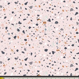 May include: Pink fabric with a terrazzo pattern. The fabric is covered in small, irregular shapes of black, white, gray, brown, and blue.
