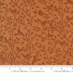 May include: A fabric featuring a repeating pattern of birds on branches with leaves and small flowers. The birds and branches are a darker brown against a lighter orange backdrop. The fabric has a textured appearance.