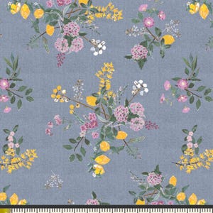 May include: A blue fabric with a repeating pattern of yellow lemons, pink and purple flowers, and green leaves. The fabric is measured with a ruler in inches.