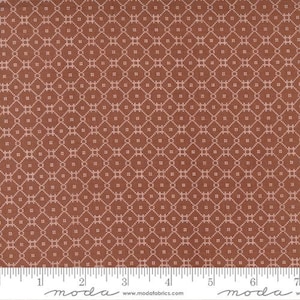 May include: A brown fabric with a white geometric pattern. The pattern is made up of small squares and diamonds.