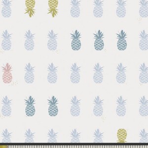 May include: A repeating pattern of stylized pineapples in various colors, including blue, green, and pink, on a cream background. The image includes a measuring tape showing 1 inch increments.