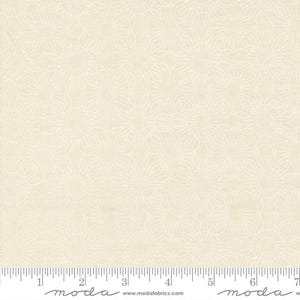 May include: Cream-colored fabric with a repeating floral pattern. The design features delicate, interconnected lines forming stylized flower shapes. A ruler is at the bottom, marked in inches.