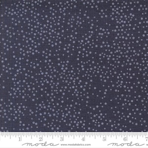 May include: A dark blue fabric with a white polka dot pattern. The fabric is textured and has a subtle sheen. The fabric is shown with a ruler for scale.