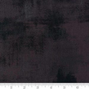 May include: A dark grey fabric with a subtle mottled texture. The fabric has a slightly purple hue and a distressed look.