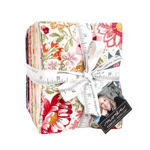 May include: A stack of floral fabric squares tied with a white ribbon printed with measurements. The fabric features red, pink, and orange flowers on a cream background. A tag with a woman's photo and the words "moda FABRICS + SUPPLIES" is attached.