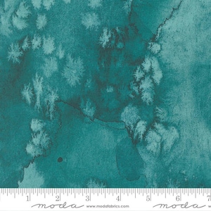 May include: Teal fabric with a watercolor effect. The fabric features a mottled pattern of teal and dark teal hues, with lighter teal accents resembling brushstrokes. The fabric has a textured appearance, and a ruler is at the bottom. The fabric is from Moda Fabrics.