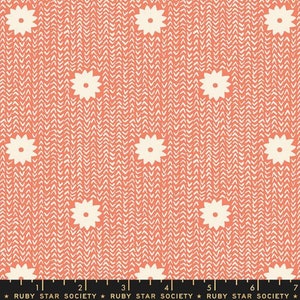 May include: Coral pink fabric with a white chevron pattern and white stylized flower designs. The fabric has a ruler with the text "Ruby Star Society" printed on it.