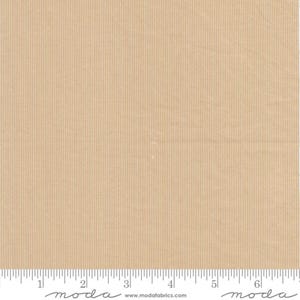 May include: Tan fabric with vertical ribbed texture. The fabric has a ruler along the bottom edge, with measurements in inches. The fabric is a solid colour and appears to be a cotton or linen blend.