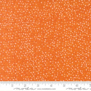 May include: A vibrant orange fabric featuring a dense pattern of small, off-white dots scattered across a background of thin, intersecting dark orange lines. The bottom edge displays a white selvage with the text moda www.modafabrics.com.
