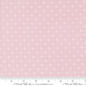 May include: Pink fabric with a white repeating pattern of small circles. The fabric has a grid pattern with white lines. The fabric is labelled "moda" at the bottom.